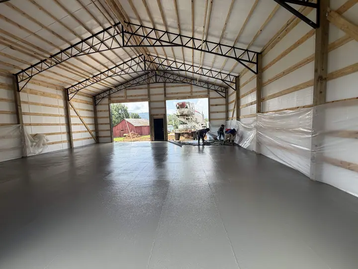 Large smooth concrete floor inside a barn-style commercial building