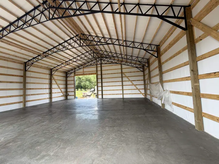 Wide concrete slab floor inside a steel-framed building