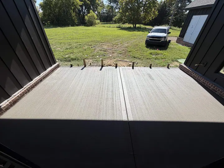 Smooth concrete slab between the open doors of a metal building