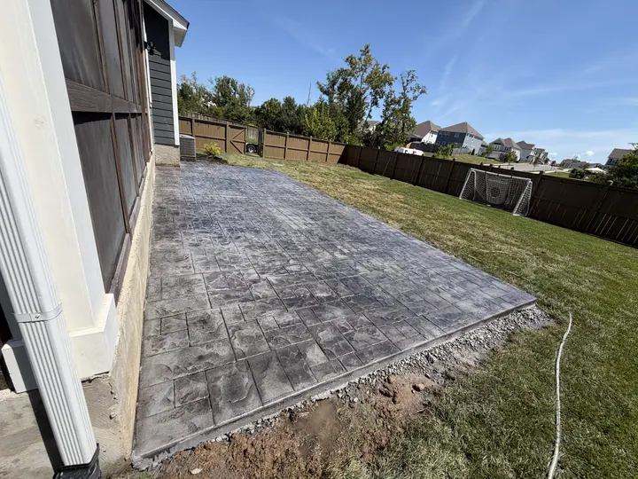 Decorative stamped concrete patio next to a house