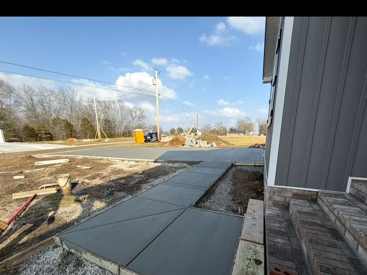 Poured front walkway and a concrete entry area beside a home