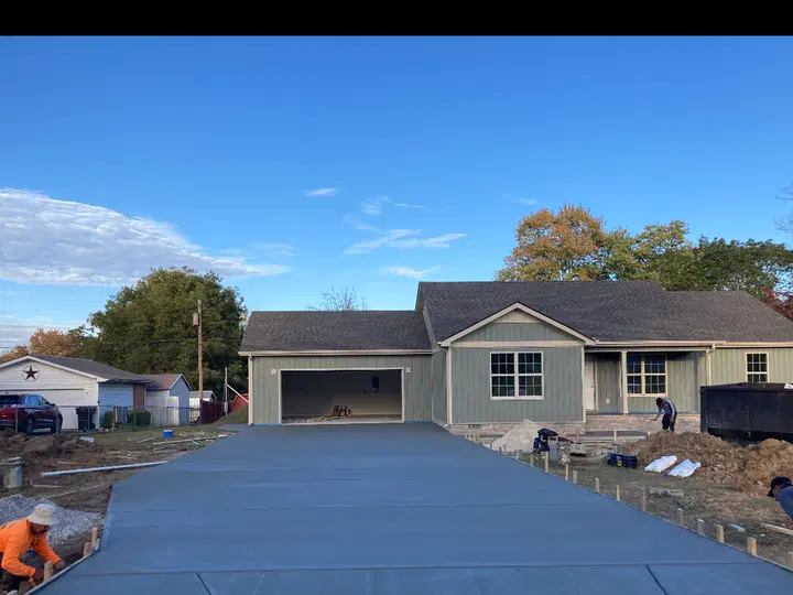 Fresh sectioned concrete driveway in front of a residence