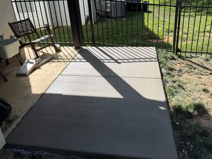Small shaded concrete porch near a back yard