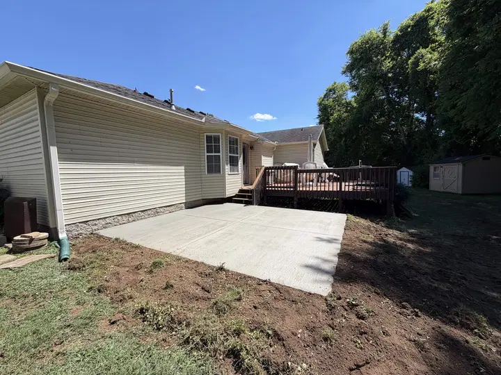 Bright finished concrete patio behind a residential house