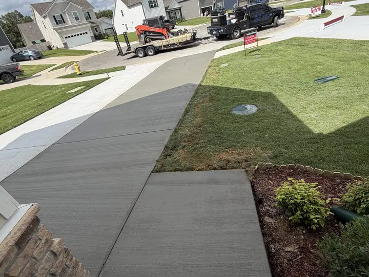 Smooth curved sidewalk alongside a grassy yard