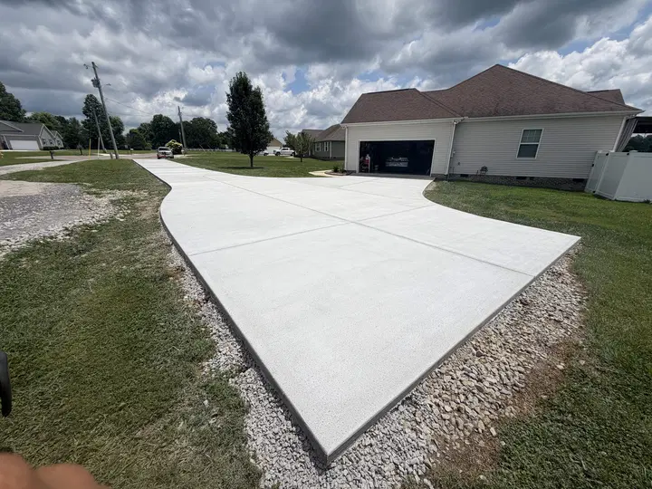 Large concrete driveway in front of a single-story house